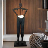 Humanoid Sculpture Holding Floor Lamp